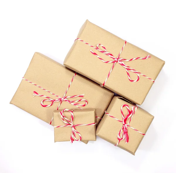 Brown paper parcel tied with red and white string on white backg — Stock Photo, Image