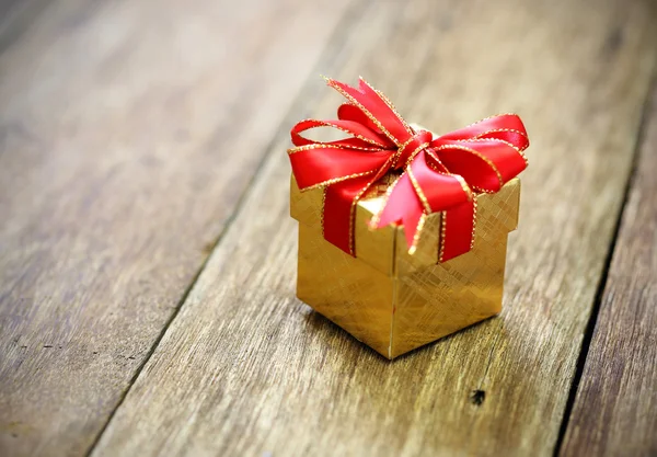 Gift box on old wood table — Stock Photo, Image