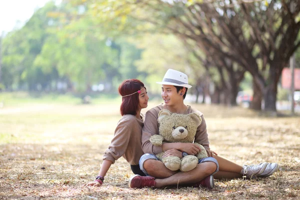 Attractive asian couple in love together in the park — Stock Photo, Image