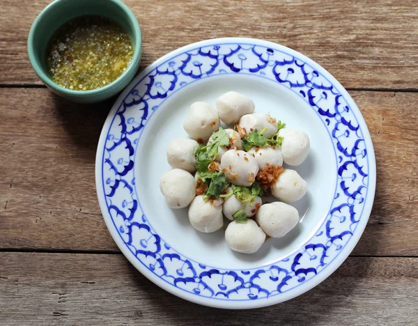 Fish meat ball in plate on wood table — Stock Photo, Image