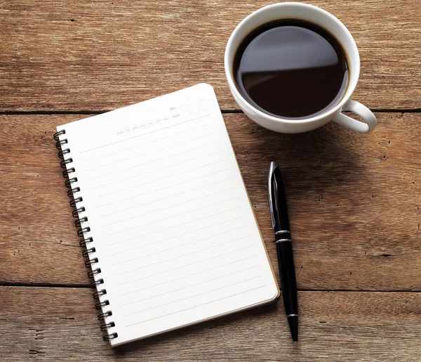 Open a blank white notebook, pen and cup of coffee on wood desk — Stock Photo, Image