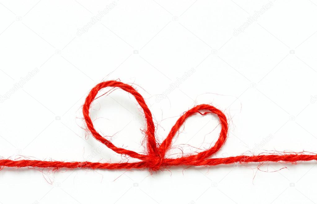 Red string bow on a white background.
