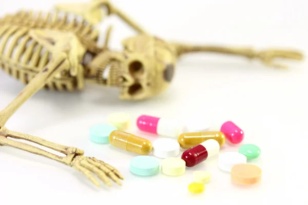 Skeleton with drug on white background over dose concept. — Stock Photo, Image