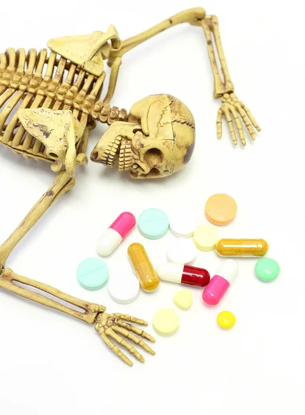 Skeleton with drug on white background over dose concept. — Stock Photo, Image