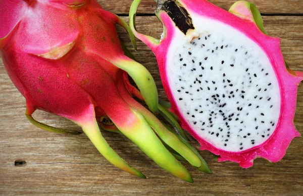 Juicy pink pitaya on wooden table closeup — Stock Photo, Image