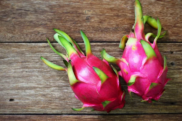 Juicy pink pitaya on wooden table closeup — Stock Photo, Image