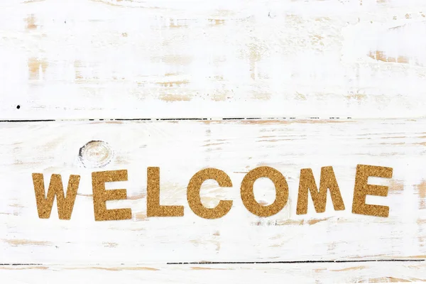 The word welcome cork on white wood background — Stock Photo, Image
