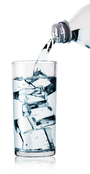 Water being poured into glass from bottle — Stock Photo, Image