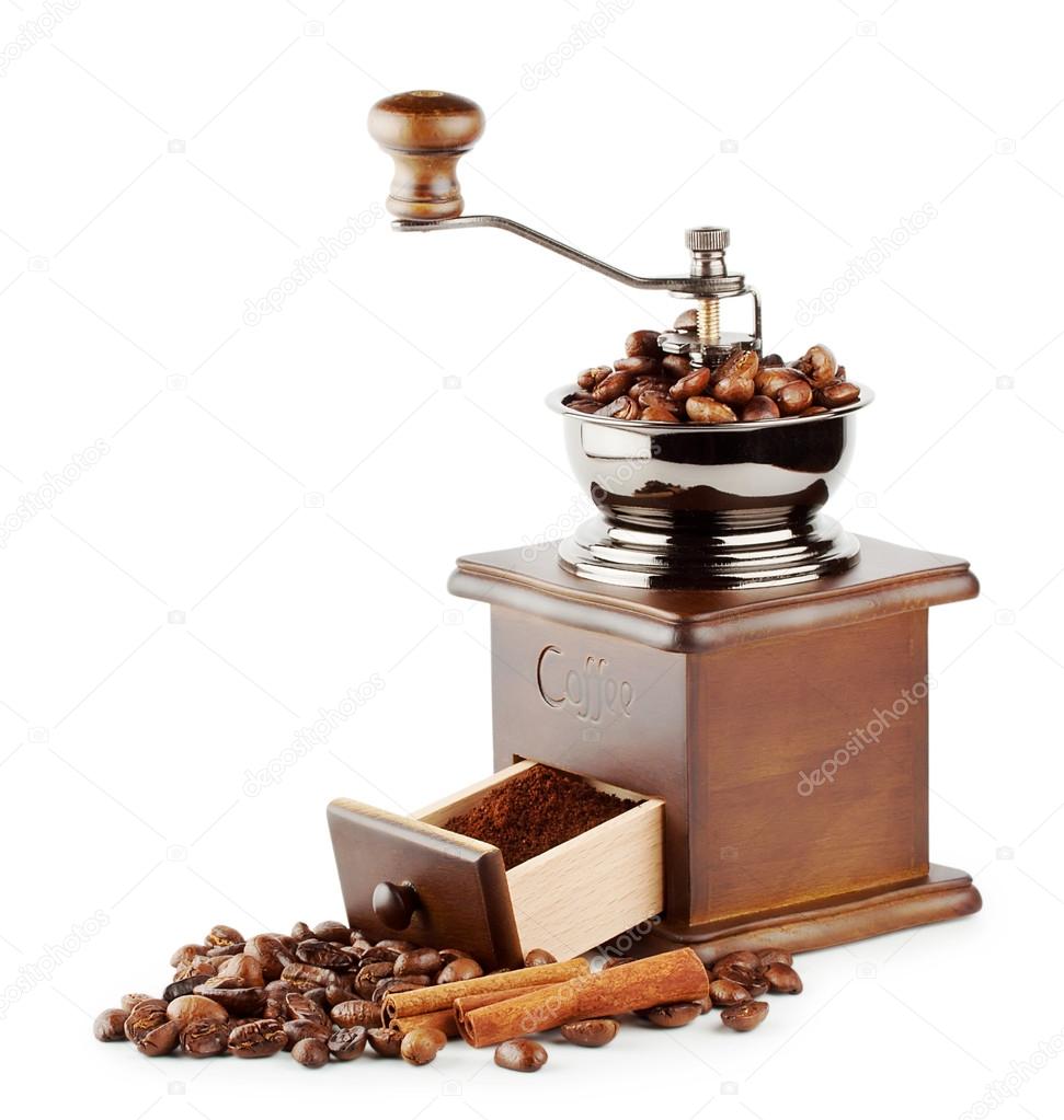 Wooden coffee grinder with beans and cinnamon