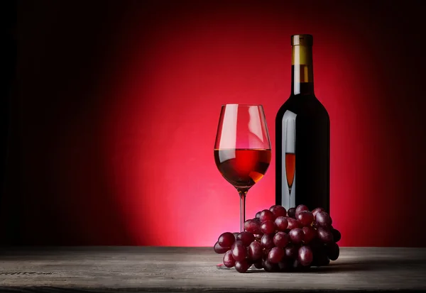 Bottle and glass of wine with grapes Stock Picture