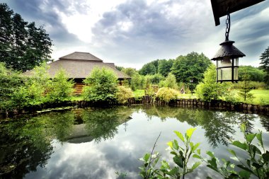 Lake under a lamp with wooden house