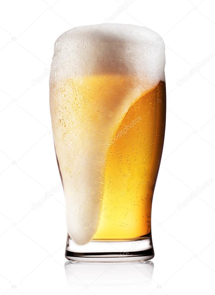 Glass of light beer with white foam
