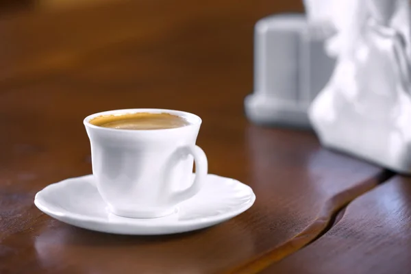 White cup of coffee on wooden table — Stock Photo, Image