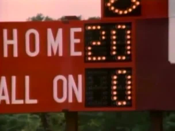 Scoreboard at high school football game — Stock Video