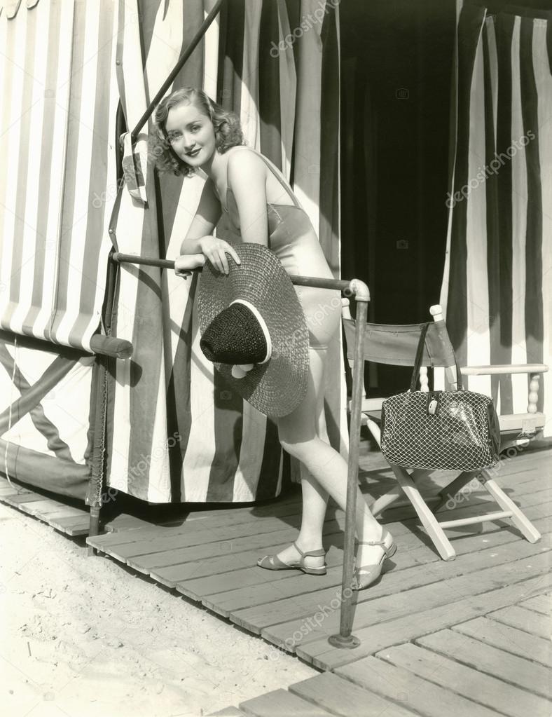 Woman holding sun hat