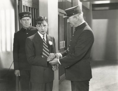 Guard removing handcuffs