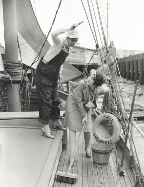 Woman sweeping boat — Stock Photo, Image