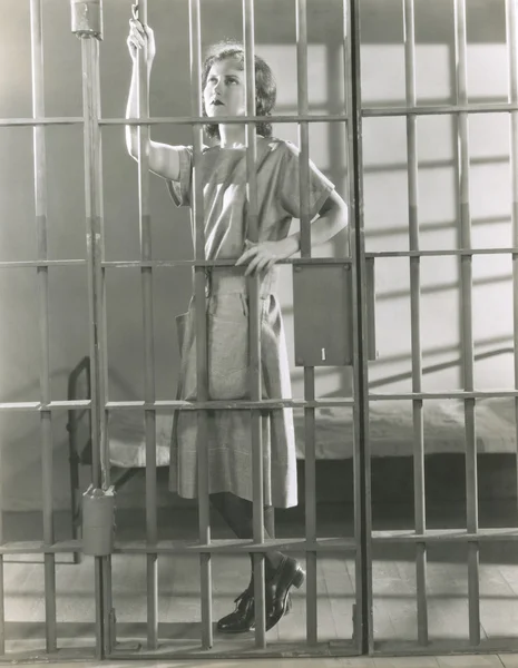 Woman standing in prison cell — Stock Photo, Image