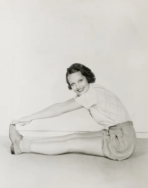 Woman touching her toes — Stok fotoğraf