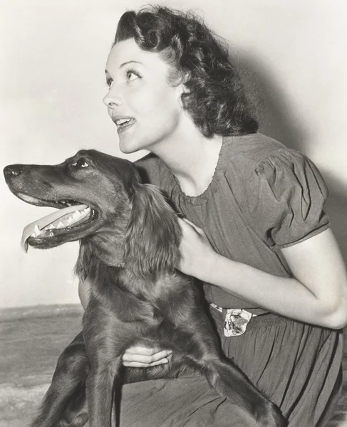 Woman holding her Irish setter — Stock Photo, Image