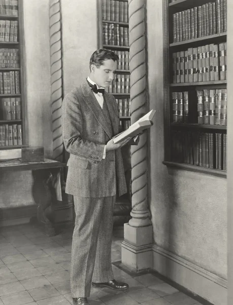 Man reading library book — Stock Photo, Image