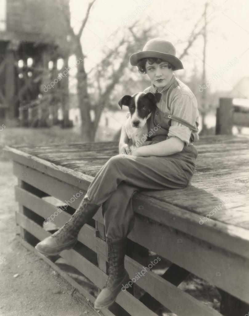 Woman sitting outdoors with her dog