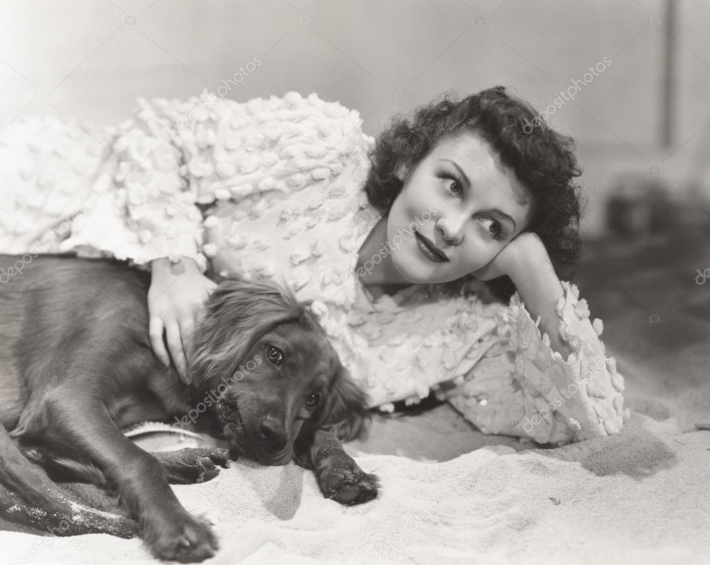 Woman lying with dog