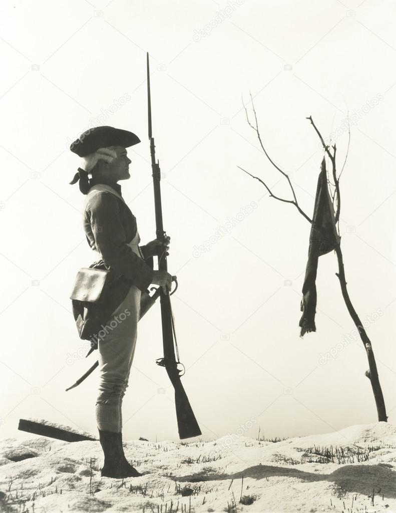 soldier looking at flag