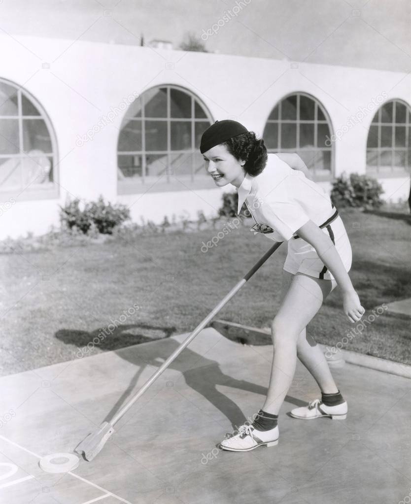 woman playing shuffleboard