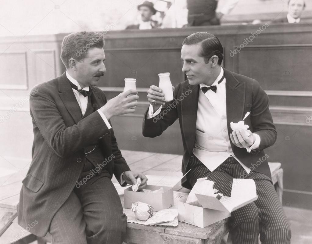 men toasting with milk bottles