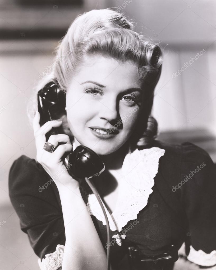 woman holding telephone receiver