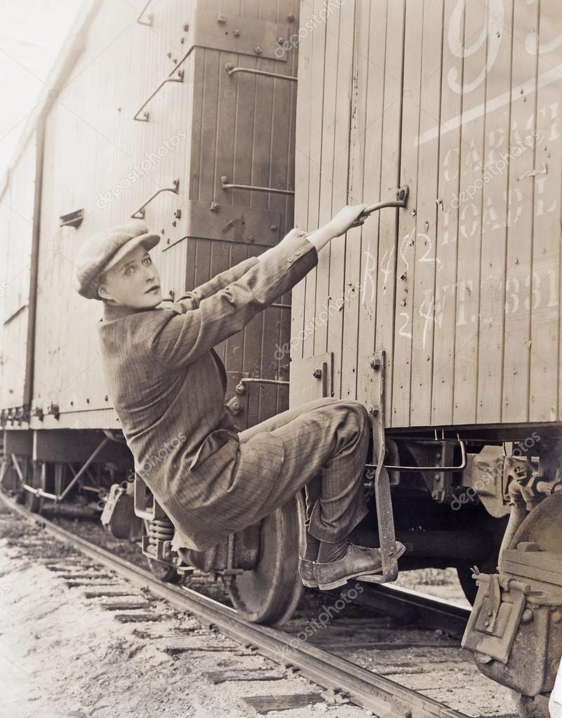Hobo climbing freight train Stock Photo by ©everett225 82900698