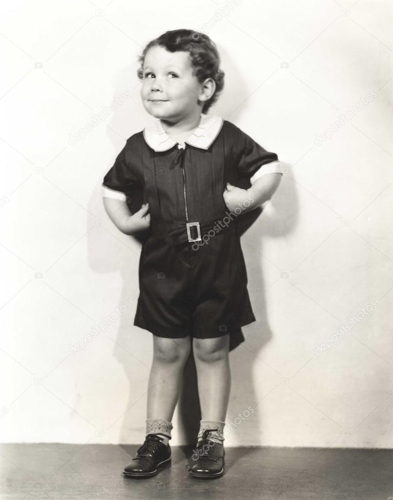 Child posing with hands on hips