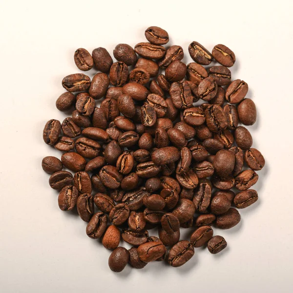 Pile of dark roasted coffee beans on white background — Stock Photo, Image