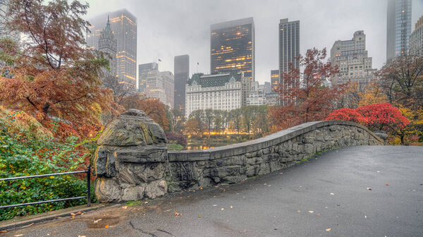 Gapstow Bridge in Central Park in late autumn with mist and rain, fog