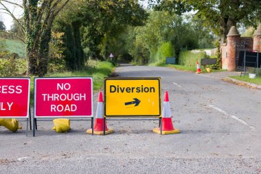 UK yellow diversion sign and road closed signs on a country road in Buckinghamshire clipart