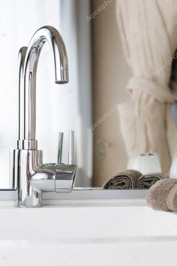 Contemporary bathroom sink, closeup of wash basin and mixer tap, UK