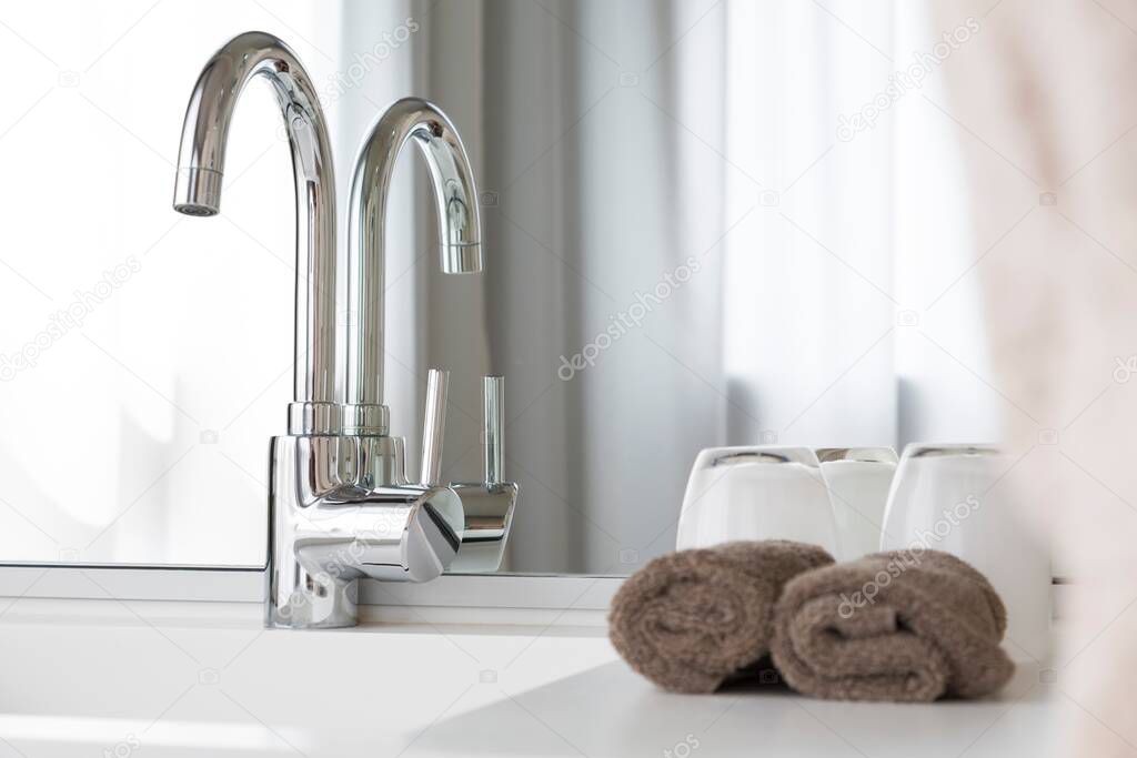 Bathroom interior design, counter top, wash basin or sink and  mixer tap, UK