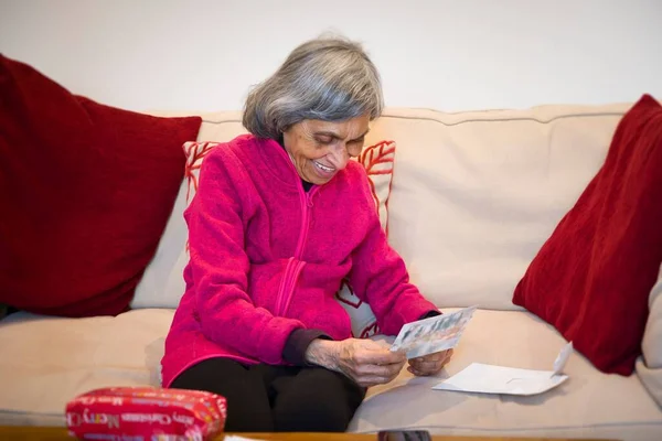Indian Older Woman Senior Opening Christmas Present Gift Card Sitting — Stock Photo, Image