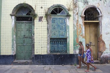 Brazilian Women Walking Past Neglected Architecture