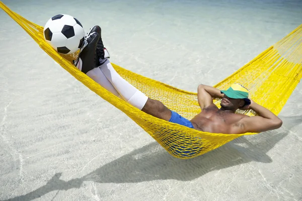 Brazilian Footballer Relaxing with Soccer Balll in Beach Hammock — Stockfoto