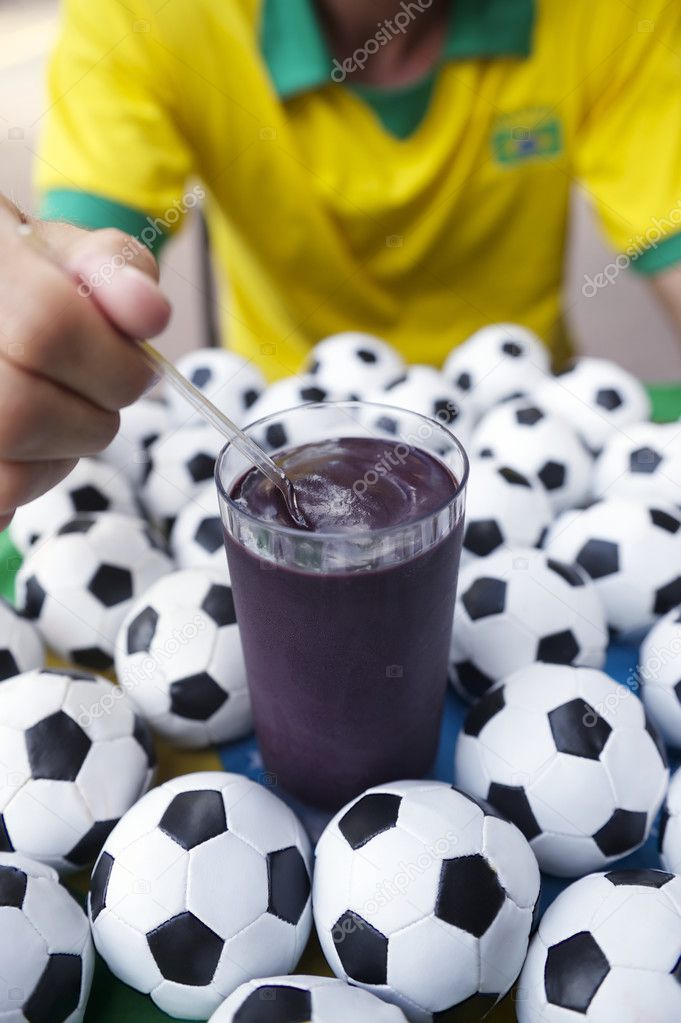 Brazilian Soccer Player Eating Acai with Footballs