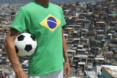Favela Footballer Standing with Soccer Ball at Slum
