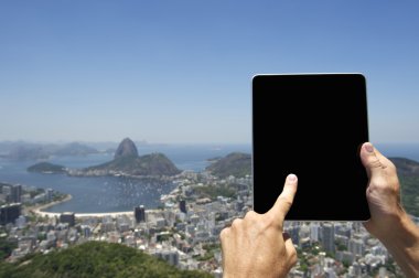 Traveling Tourist Using Tablet at Rio de Janeiro Brazil Skyline