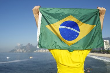 Brazilian Football Player Holding Flag at the Sea