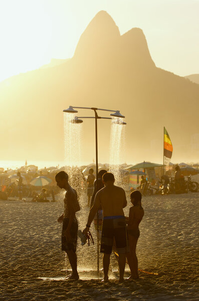Brazilian Men Showering at Sunset Ipanema Rio