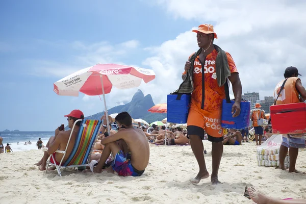 Leveranciers en zonaanbidders op Ipanema Beach Rio — Stockfoto