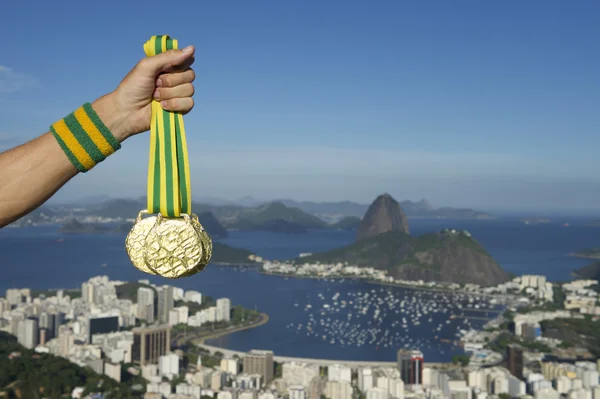 Hand of Athlete Holding Gold Medals Rio Skyline — Stock Photo, Image