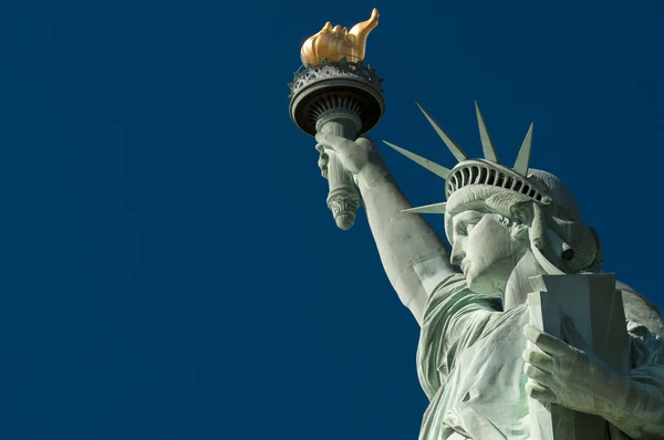 Profile of the Statue of Liberty against Bright Blue Sky