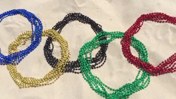 Karneval Perlen olympische Ringe im Sand Rio — Stockvideo